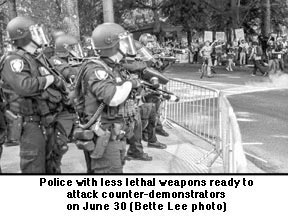 June 30 photo of police with less lethal weapons ready to 
attack 
counter-demonstrators. Photo by Bette Lee.