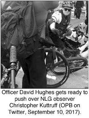 Officer David Huges gets ready to push over NLG observer 
Christopher Kuttruff (OPB on Twitter, September 10, 2017).